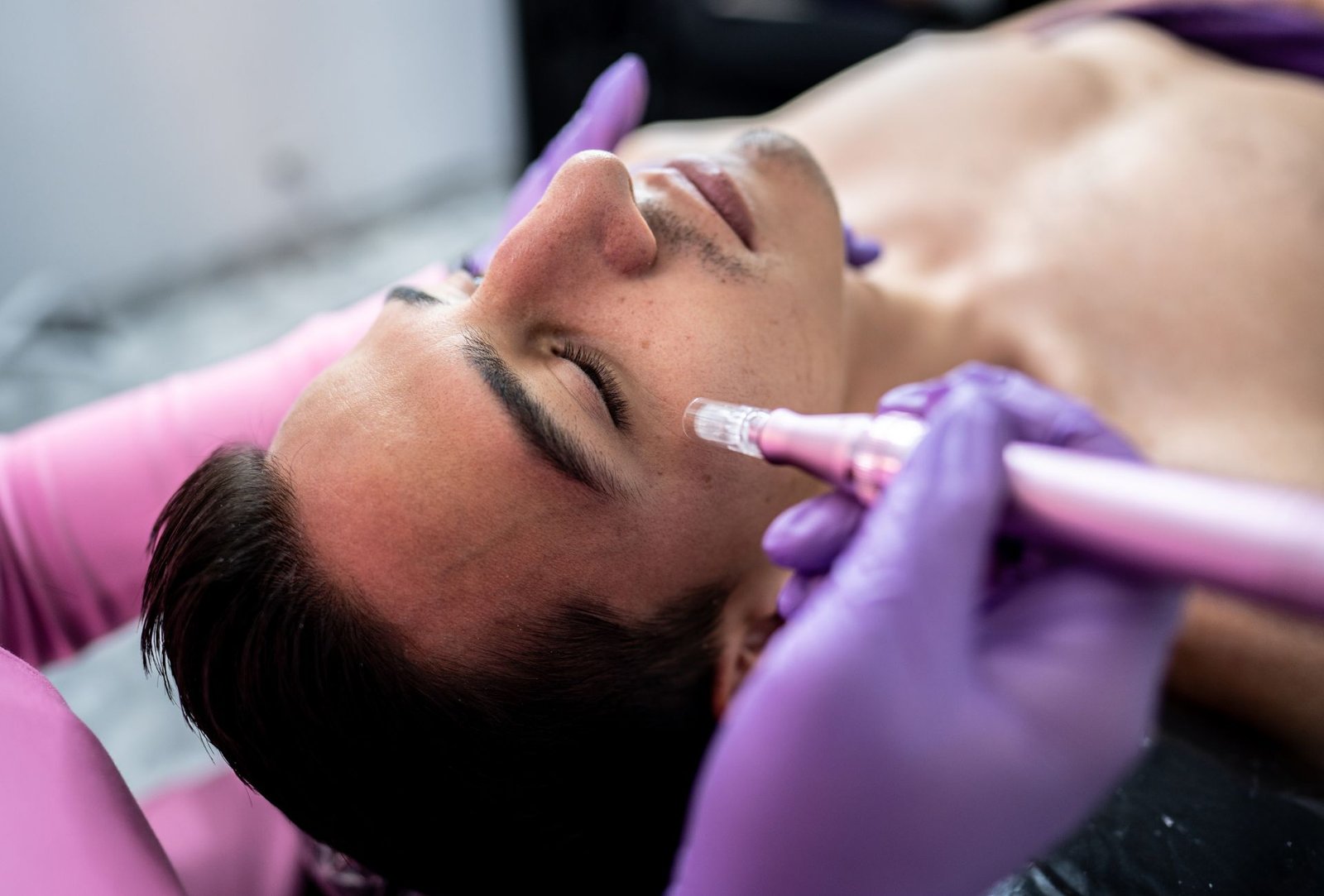 man receiving an aesthetic facial treatment at a beauty clinic.
